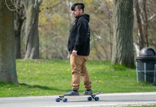 man in park on a longboard