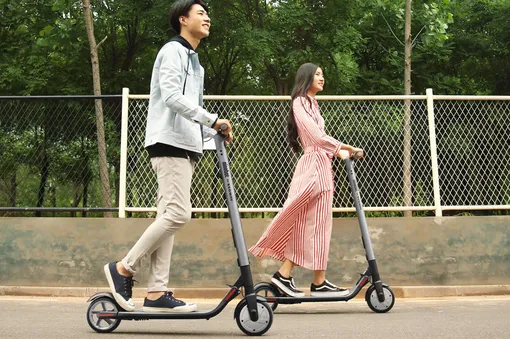 kick scooter asian man and woman